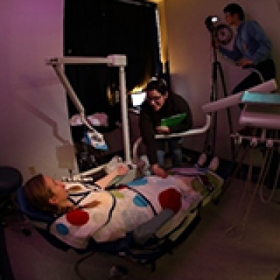 USC scientists developed a sensory adapted dental environment that featured dim lights, a weighted wrap, calm music, and image projections on the ceiling. 