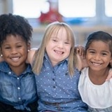 Children smiling and looking at the camera